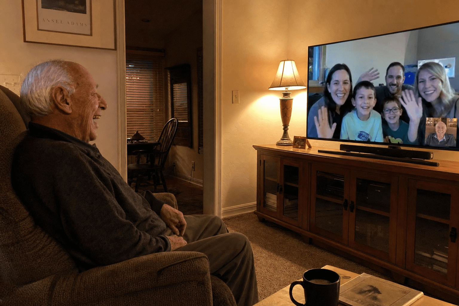 A grandfather on a video call shown on a television
